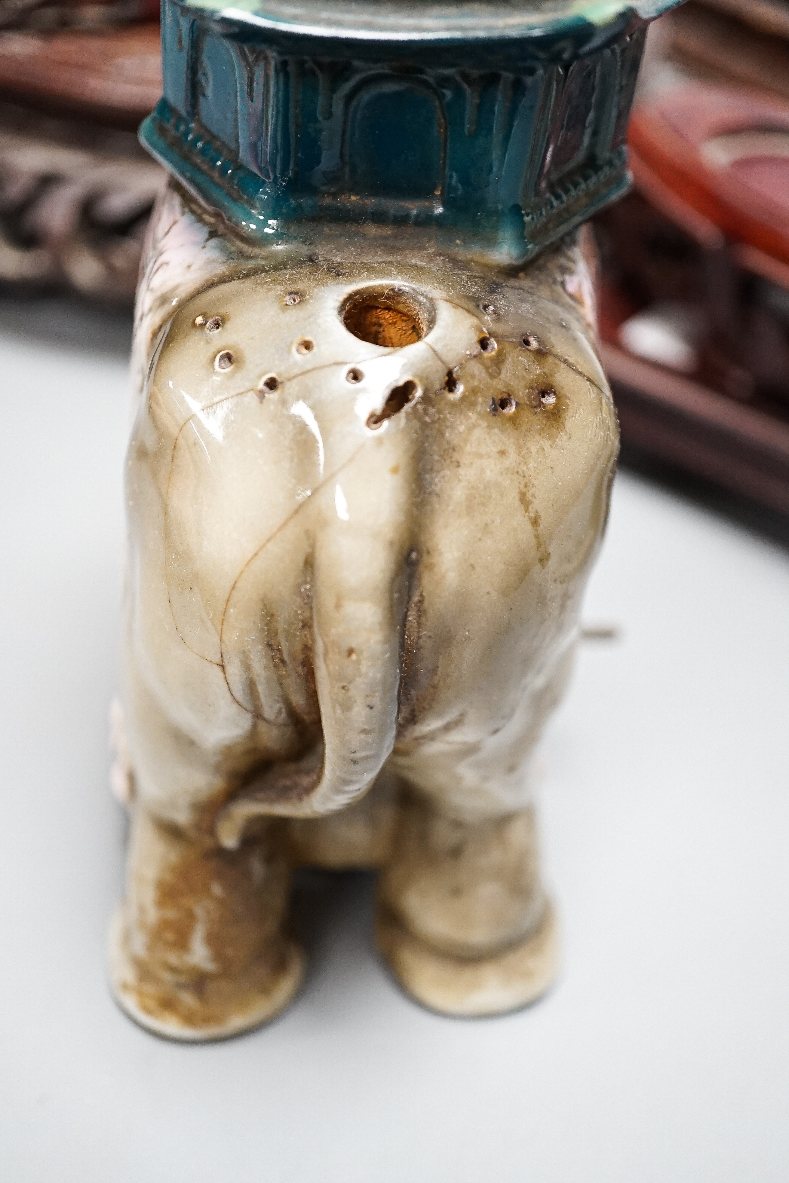 A pair of hard stone vases, 2 hard stone figural carvings, a porcelain elephant, and a quantity of hardwood stands